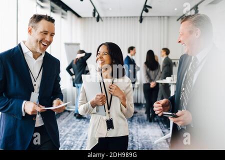 Happy entrepreneurs discussing in office seminar Stock Photo