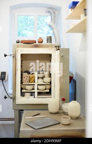 Various earthenware on shelves in art studio Stock Photo