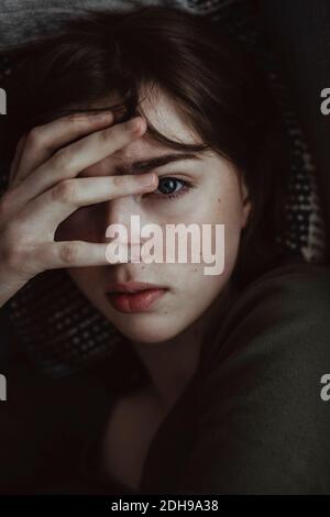 Portrait of stressed woman on sofa Stock Photo