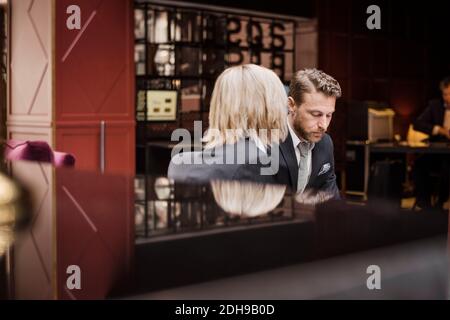Business people sitting in hotel reception during meeting Stock Photo