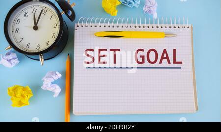 Conceptual hand writing showing Set Goal. Business photo showcasing Act on a specific and clearly laid out plans SET GOALS written on notebook, Wrinkl Stock Photo