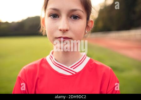 Portrait of confident female soccer player standing on field Stock Photo