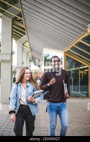Happy male and female students at university Stock Photo