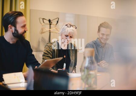 Happy colleagues working together in board room Stock Photo