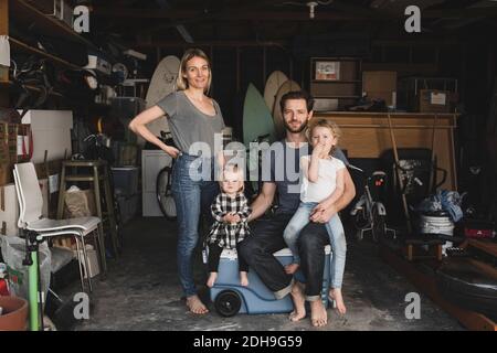Portrait of parents and children in storage room of house Stock Photo