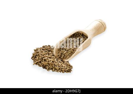 Food ingredients heap of cumin in a wooden scoop, on white background Stock Photo