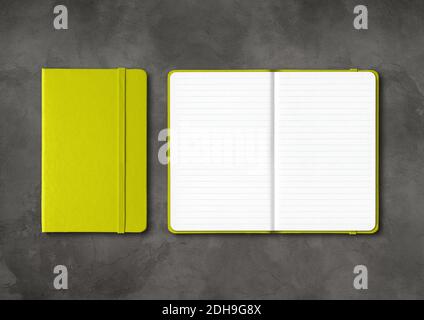 Lime green closed and open lined notebooks on dark concrete background Stock Photo