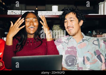 Happy businesswoman working with coworker in creative office Stock Photo