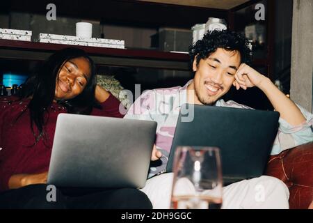 Happy businessman working with smiling coworker in creative office Stock Photo
