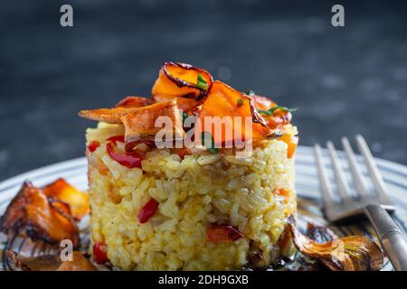 Boiled rice with fried red peppers, carrots and onions, close up. Food background. Healthy food Stock Photo