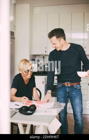Man and woman having fun working from home Stock Photo