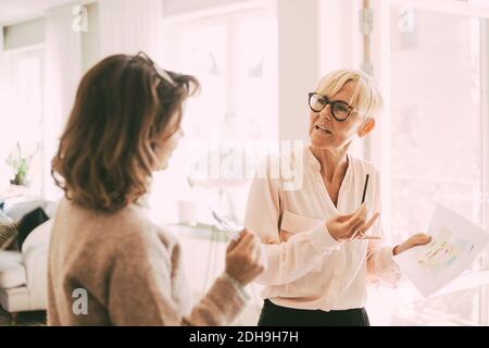 Two businesswomen having a conversation at home Stock Photo