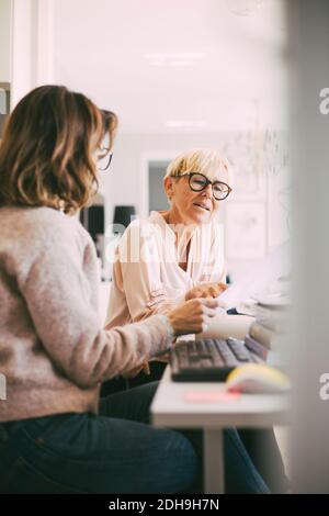 Two businesswomen at home office having a discussion Stock Photo