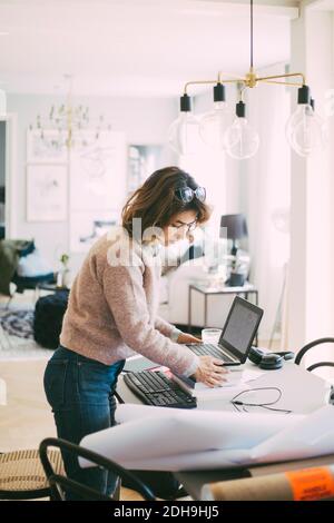 Woman setting up workplace at home Stock Photo