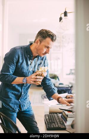 Businessman having lunch working from home Stock Photo