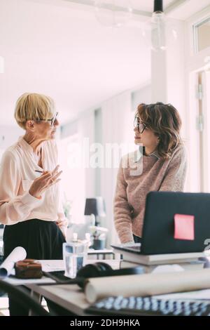 Two women having a discussion working at home Stock Photo