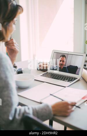 Coworkers having an online meeting at home Stock Photo