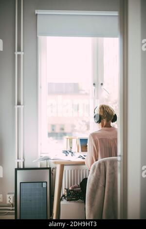 Woman in home office working with laptop Stock Photo