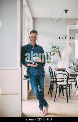 Portrait of man with laptop and coffee at home Stock Photo