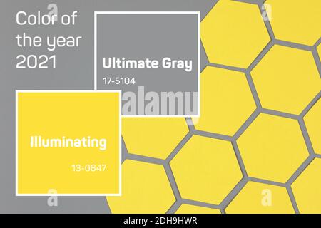 geometric composition with yellow paper hexagons on neutral gray background Stock Photo