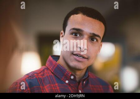Smiling businessman looking away at office Stock Photo