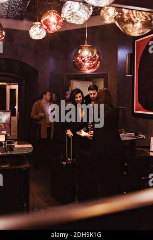 Couple standing at reception desk in hotel Stock Photo