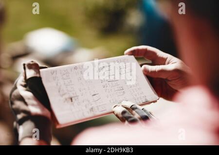 Cropped image of senior couple holding wooden plank with numbers Stock Photo