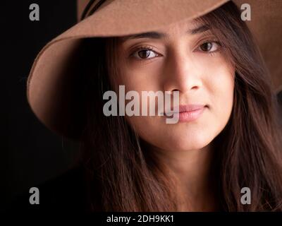 Beautiful young Nepalese woman wearing a hat and smiling Stock Photo