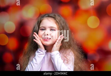 Portrait of happy smiling child girl on colored background. Laughing people. Stock Photo
