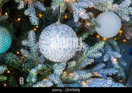 Christmas balls of on a blurred background, decorated with a silver branch. Photo for the New Year banner Stock Photo