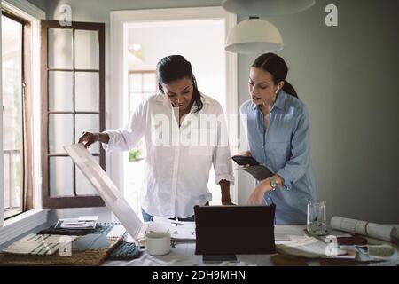 Female architects working at table in home office Stock Photo