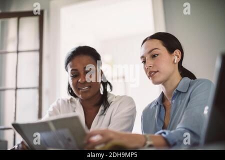 Low angle view of architects discussing while working at table in home office Stock Photo