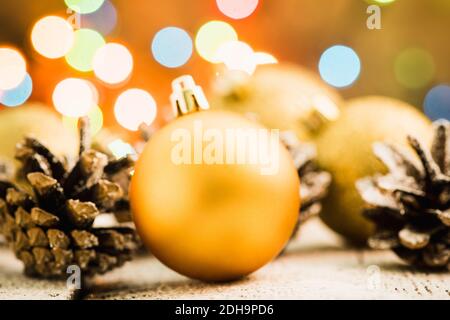 Christmas balls on snowy wooden table with christmas decorations. Selective focus. Shallow depth of field. Stock Photo