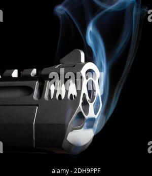 Smoking gun barrel that is on a black background Stock Photo