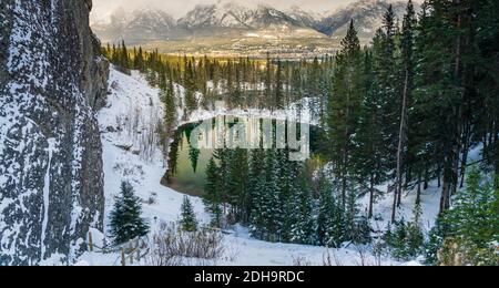Upper and Lower Grassi Lakes in winter season, Town of Canmore and the Bow River valley in the distance. Alberta, Canada. Stock Photo