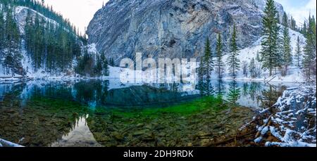 Panorama view of Upper Grassi Lakes in winter season. The reflection of the lake surface like a mirror. Canmore, Alberta, Canada.