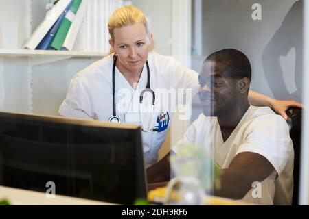 Male and female nurses using desktop computer in hospital Stock Photo