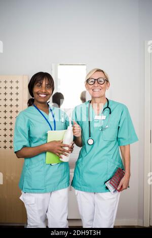 Portrait of smiling female healthcare workers standing in clinic Stock Photo