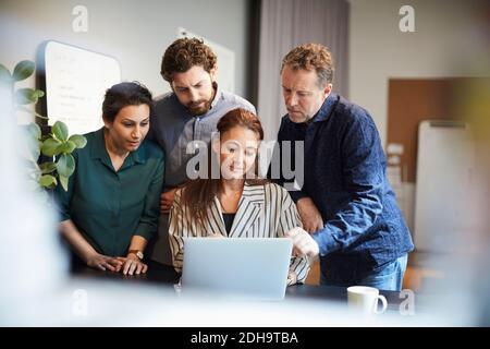 Creative professionals using laptop at office Stock Photo