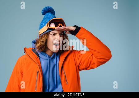 Caucasian surprised sportsman posing and looking aside isolated over blue background Stock Photo