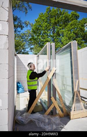 Side view of male architect working at construction site on sunny day Stock Photo