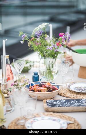 Bowl of food arranged on table during party at building terrace Stock Photo