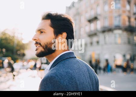 Man with beard looking away during city exploration Stock Photo