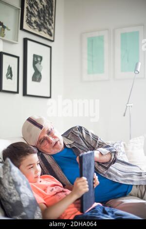 Grandfather and grandson using digital tablet at home Stock Photo