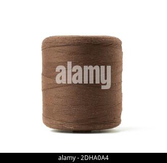 Large spool with brown cotton thread isolated on white background Stock Photo