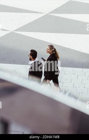 High angle view of business people walking and talking outdoors Stock Photo