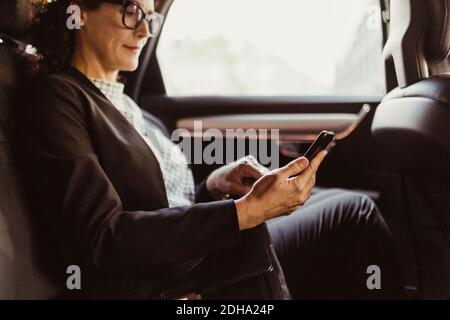 Entrepreneur using mobile phone while sitting in car Stock Photo