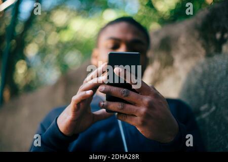 Low angle view of young man using smart phone Stock Photo