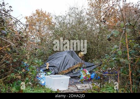 A makeshift camp in a hedgerow of a homeless person Stock Photo