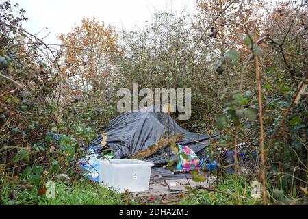A makeshift camp in a hedgerow of a homeless person Stock Photo